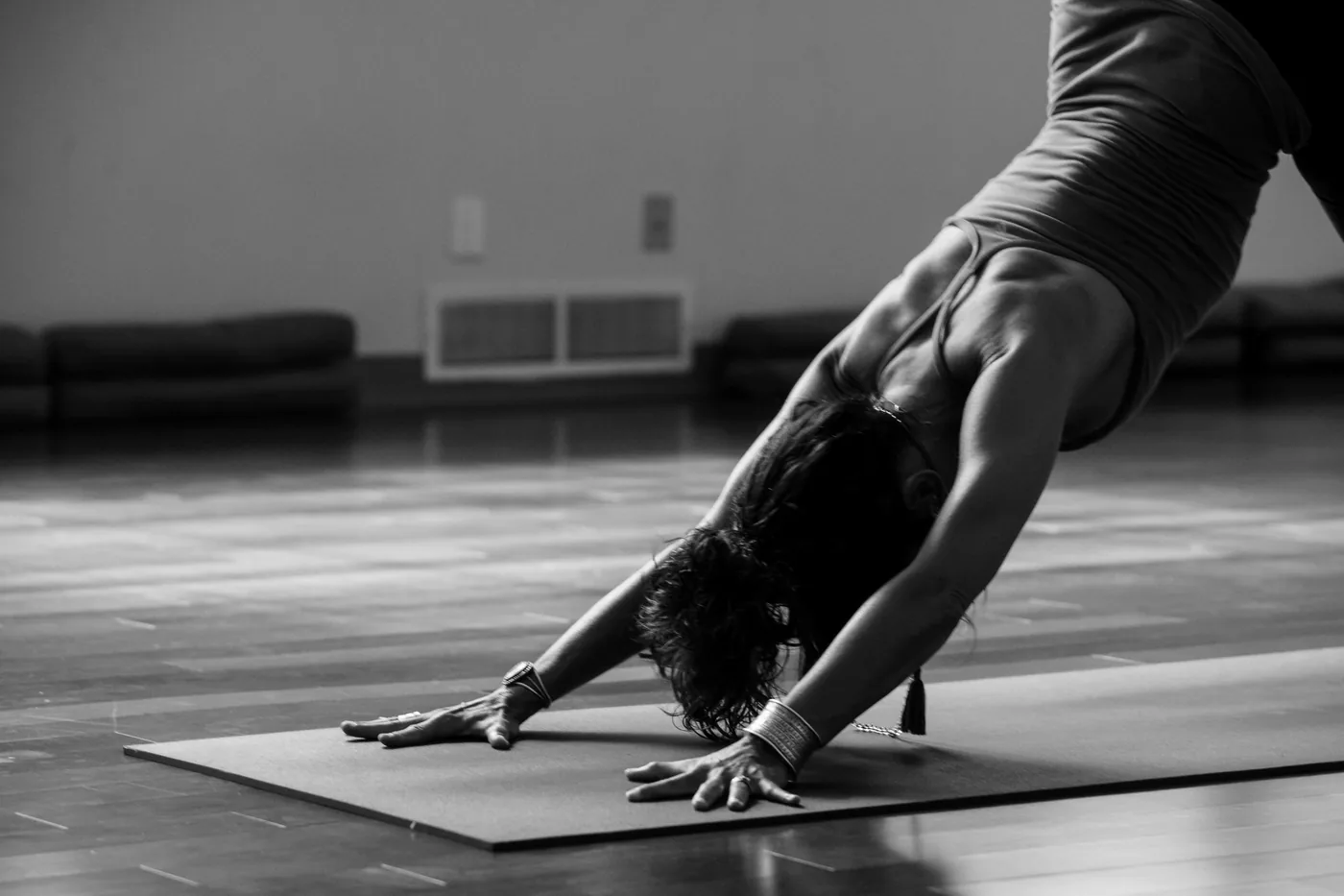 Downward dog stretch on a mat in the studio